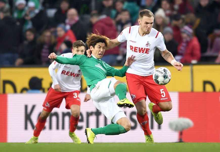 COLOGNE, GERMANY - DECEMBER 21: Yuya Osako of SV Werder Bremen tackles Rafael Czichos of 1. FC Koeln during the Bundesliga match between 1. FC Koeln and SV Werder Bremen at RheinEnergieStadion on December 21, 2019 in Cologne, Germany. (Photo by Jörg Schüler/Bongarts/Getty Images)