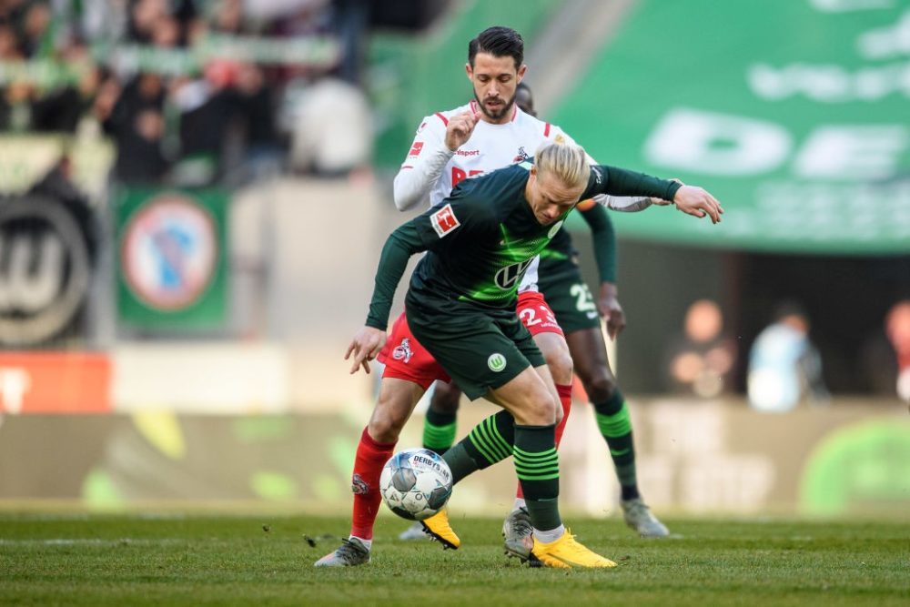  COLOGNE, GERMANY - JANUARY 18: Xaver Schlager of Wolfsburg is challenged by Mark Uth of Cologne during the Bundesliga match between 1. FC Koeln and VfL Wolfsburg at RheinEnergieStadion on January 18, 2020 in Cologne, Germany. (Photo by Jörg Schüler/Bongarts/Getty Images)