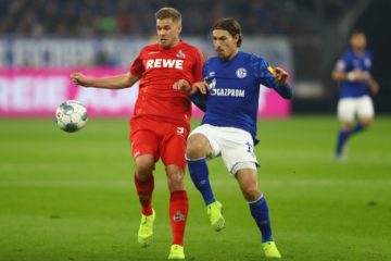 GELSENKIRCHEN, GERMANY - OCTOBER 05: Benjamin Stambouli of FC Schalke 04 is challenged by Simon Terodde of 1. FC Koln during the Bundesliga match between FC Schalke 04 and 1. FC Koeln at Veltins-Arena on October 05, 2019 in Gelsenkirchen, Germany. (Photo by Dean Mouhtaropoulos/Bongarts/Getty Images)