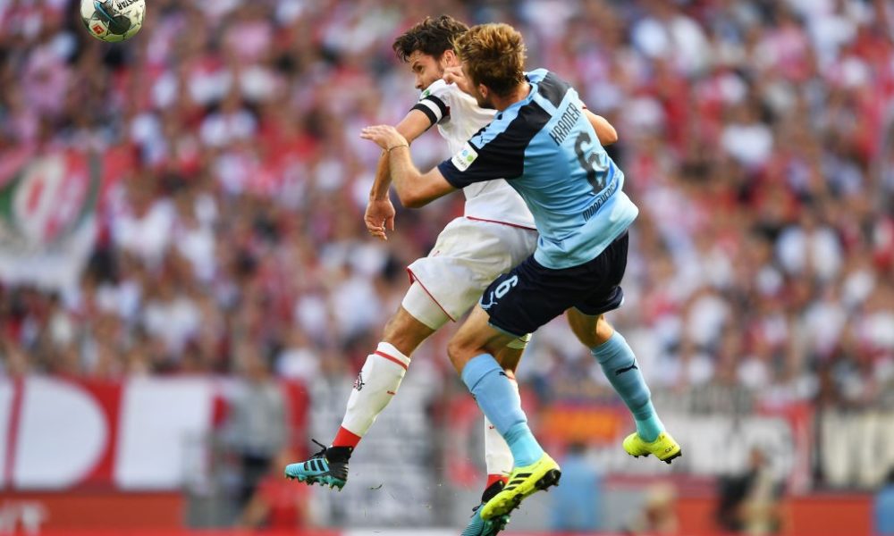 COLOGNE, GERMANY - SEPTEMBER 14: Jonas Hector of 1. FC Koln and Christoph Kramer of Borussia Monchengladbach jump for the ball during the Bundesliga match between 1. FC Koeln and Borussia Moenchengladbach at RheinEnergieStadion on September 14, 2019 in Cologne, Germany. (Photo by Jörg Schüler/Bongarts/Getty Images)