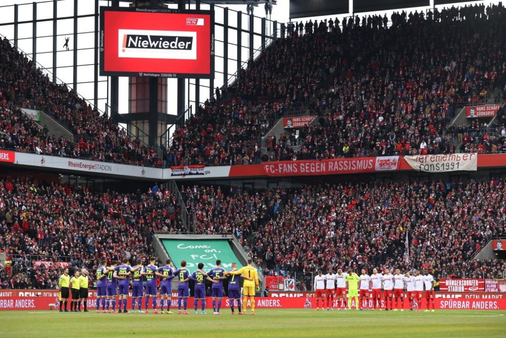  COLOGNE, GERMANY - FEBRUARY 02: The players observe a minutes silence ahead of kick-off in remembrance of the victims of the Holocaust during the Bundesliga match between 1. FC Koeln and Sport-Club Freiburg at RheinEnergieStadion on February 02, 2020 in Cologne, Germany. (Photo by Lars Baron/Bongarts/Getty Images)