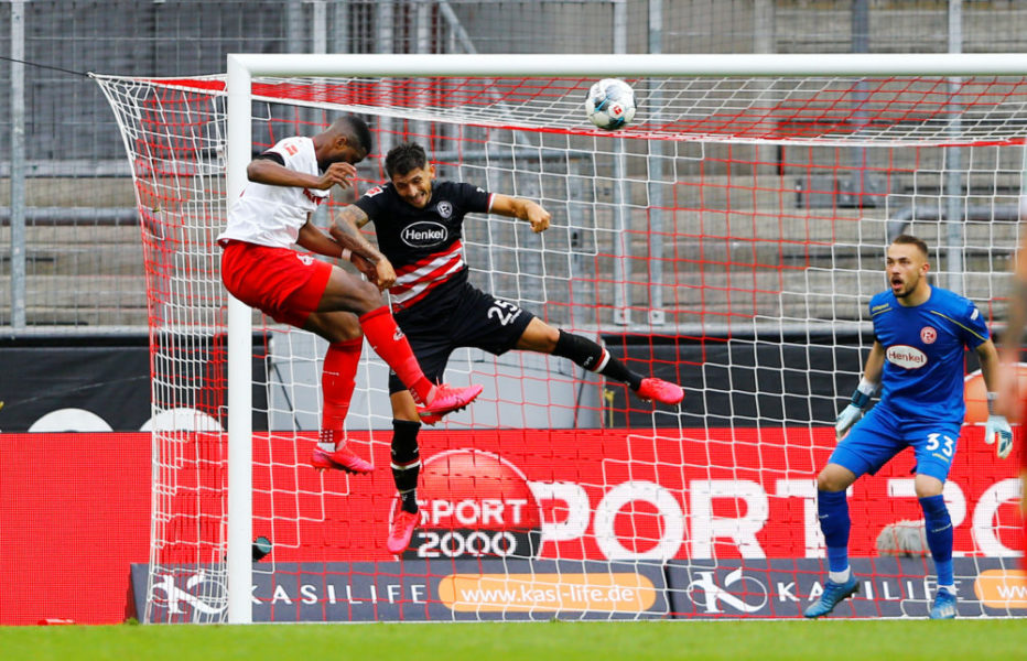 Cologne's French forward Anthony Modeste (L) scores the 1-2 with his head during the German first division Bundesliga football match FC Cologne v Fortuna Dusseldorf on May 24, 2020 in Cologne, western Germany. (Photo by Tilo SCHMUELGEN / POOL / AFP) / DFL REGULATIONS PROHIBIT ANY USE OF PHOTOGRAPHS AS IMAGE SEQUENCES AND/OR QUASI-VIDEO (Photo by TILO SCHMUELGEN/POOL/AFP via Getty Images)