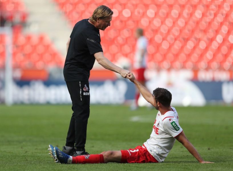 Cologne's German coach Markus Gisdol (L) and Cologne's German forward Mark Uth do a fist bump after the German first division Bundesliga football match FC Cologne v Mainz 05 on May 17, 2020 in Cologne, western Germany as the season resumed following a two-month absence due to the novel coronavirus COVID-19 pandemic. (Photo by Lars Baron / POOL / AFP) / DFL REGULATIONS PROHIBIT ANY USE OF PHOTOGRAPHS AS IMAGE SEQUENCES AND/OR QUASI-VIDEO (Photo by LARS BARON/POOL/AFP via Getty Images)