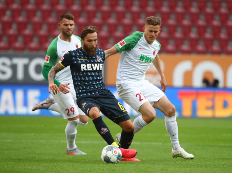 Augsburg's Icelandic forward Alfred Finnbogason (R) and Cologne's German midfielder Marco Hoeger vie for the ball during the German first division Bundesliga football match FC Augsburg v 1. FC Cologne on June 7, 2020 in Augsburg, southern Germany. (Photo by Michael DALDER / POOL / AFP) / DFL REGULATIONS PROHIBIT ANY USE OF PHOTOGRAPHS AS IMAGE SEQUENCES AND/OR QUASI-VIDEO (Photo by MICHAEL DALDER/POOL/AFP via Getty Images)