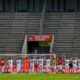 Cologne's players greet the absent fans in front of empty stands after the German first division Bundesliga football match FC Cologne v Eintracht Frankfurt on June 20, 2020 in Cologne, western Germany. (Photo by SASCHA SCHUERMANN / various sources / AFP) / DFL REGULATIONS PROHIBIT ANY USE OF PHOTOGRAPHS AS IMAGE SEQUENCES AND/OR QUASI-VIDEO (Photo by SASCHA SCHUERMANN/AFP via Getty Images)