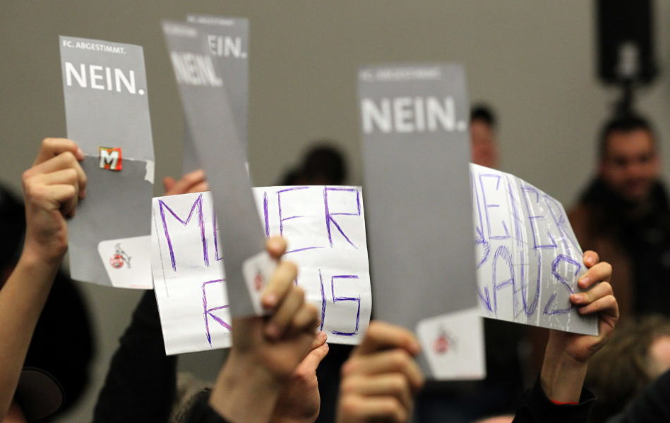 COLOGNE, GERMANY - NOVEMBER 17: Members of 1. FC Koeln hold voting letters in the air during the general meeting of 1. FC Koeln at the StaatenHaus on November 17, 2010 in Cologne, Germany. (Photo by Lars Baron/Bongarts/Getty Images)