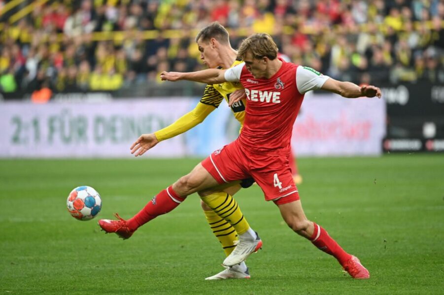 Dortmund's German forward Steffen Tigges (L) and Cologne's German defender Timo Huebers vie for the ball during the German first division Bundesliga football match Borussia Dortmund v FC Cologne in Dortmund, western Germany, on October 30, 2021. - - RESTRICTIONS: DFL REGULATIONS PROHIBIT ANY USE OF PHOTOGRAPHS AS IMAGE SEQUENCES AND/OR QUASI-VIDEO (Photo by Ina Fassbender / AFP) / RESTRICTIONS: DFL REGULATIONS PROHIBIT ANY USE OF PHOTOGRAPHS AS IMAGE SEQUENCES AND/OR QUASI-VIDEO (Photo by INA FASSBENDER/AFP via Getty Images)